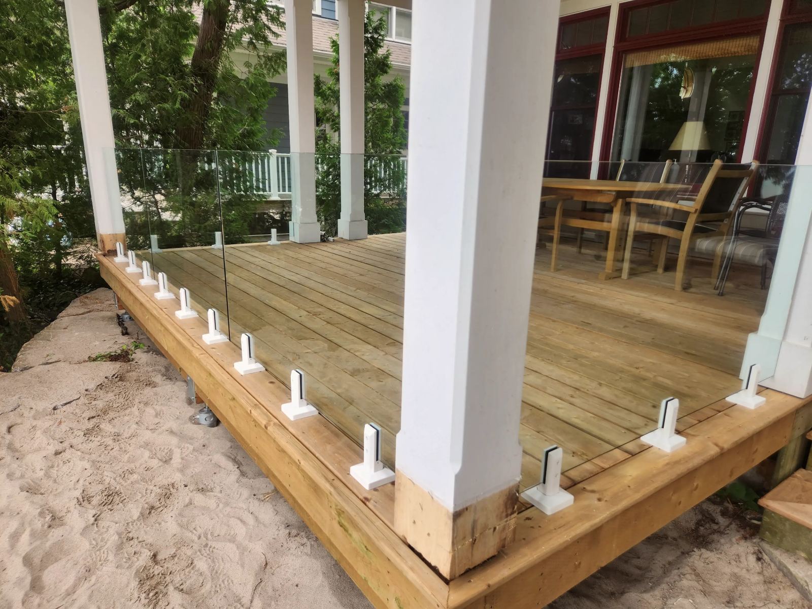 Frameless tempered glass deck railing on a lakeside deck in Guelph