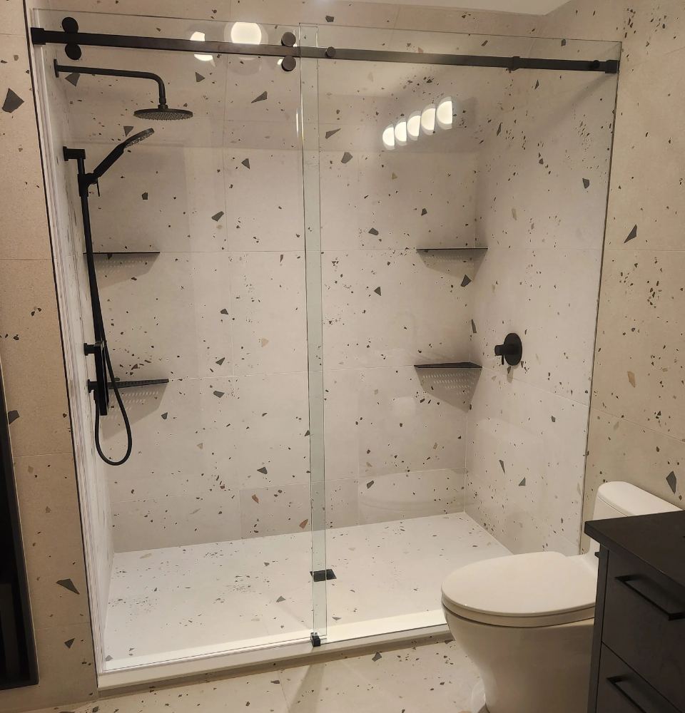 Frameless sliding shower enclosure installed by DSR Glass